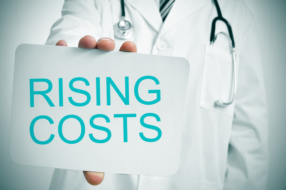 A,Doctor,Showing,A,Signboard,With,The,Word,Rising,Costs